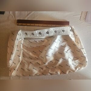 Cream and white satin belt bag with silver hardware, featuring a zipper closure